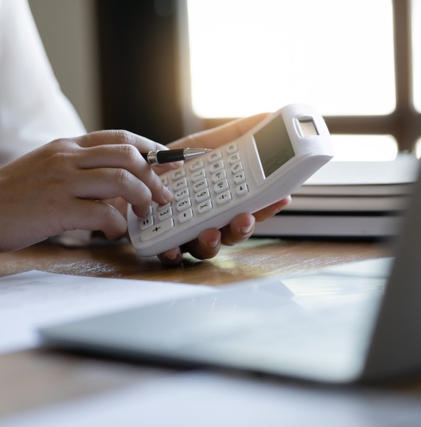 Tax specialist checking a calculation on a calculator