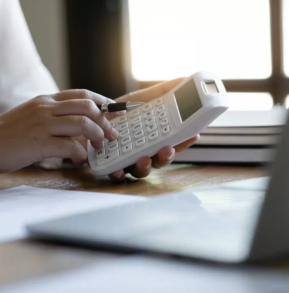 Tax specialist checking a calculation on a calculator