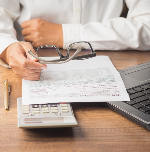 Man filling in an income tax return form
