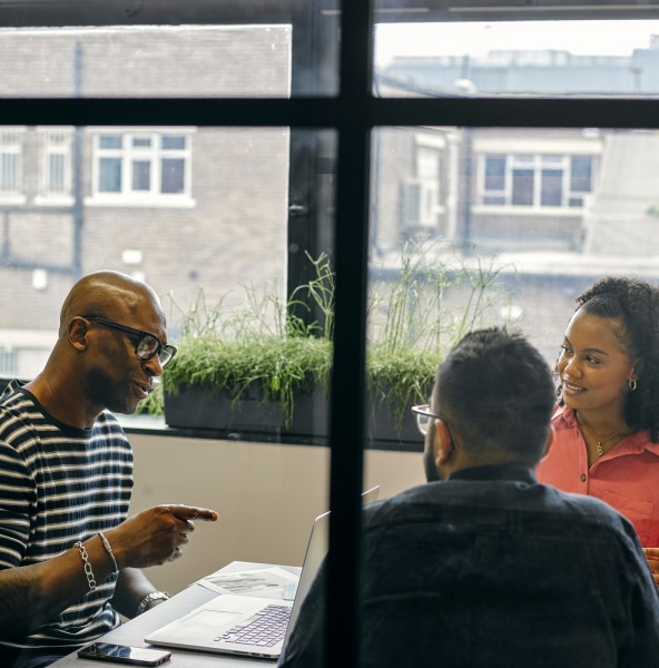 Adviser discussing documents with clients at an office table