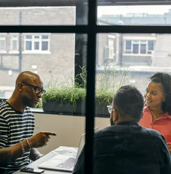 Adviser discussing documents with clients at an office table