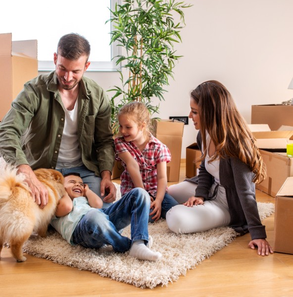A family unpacking boxes in their new home after relocating