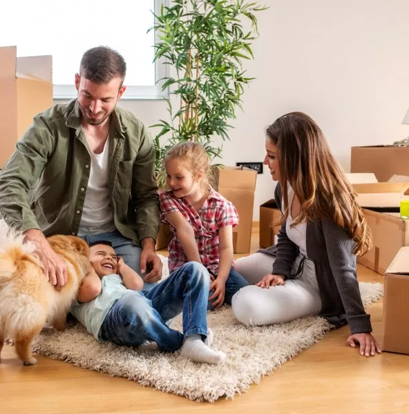 A family unpacking boxes in their new home after relocating