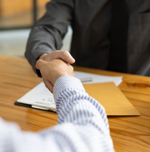 Lawyer shaking hands with a client after a consultation in an office