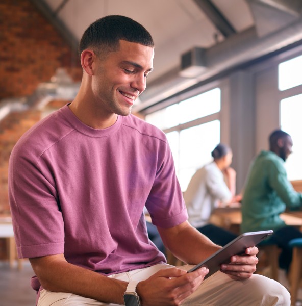 Entrepreneur working on a tablet in a modern open-plan office
